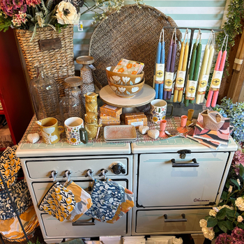 A table adorned with various candles and decorative items, creating a warm and inviting atmosphere.