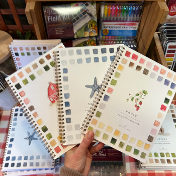A notebook featuring colorful watercolor designs on the cover, showcasing artistic patterns and textures.