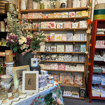A store interior showcasing a variety of items on display, including clothing, accessories, and home goods.