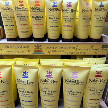 Nakai Bee hand and body lotion bottle with a sleek design, featuring a honeycomb pattern and a floral label.