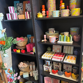 A vibrant store display with an assortment of items, including toys, books, and kitchenware, arranged for customer viewing.