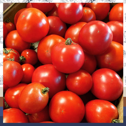 Bays Hay's MarketA close-up of a pile of fresh, vibrant red tomatoes with green stems. The smooth, shiny surfaces convey freshness and ripeness, evoking a sense of natural abundance.